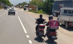 Düzce'de bir motokuryenin arızalanan motosikleti ayağıyla iterek yardım etmesi kamerada